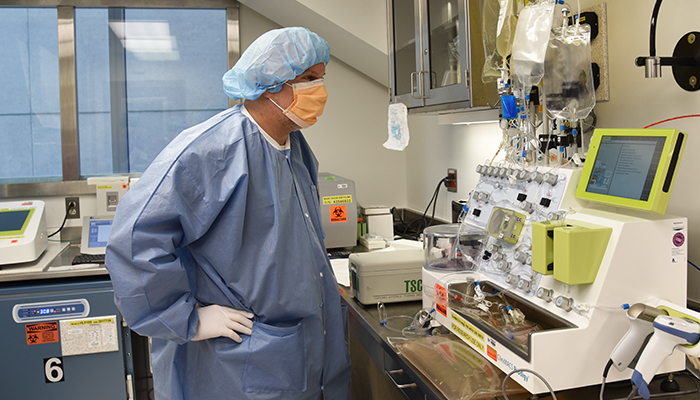 Stephan Kadauke, MD, PhD, is pictured in a “bunny suit,” also known as the personal protective equipment that is required to enter the cleanroom environment. (Photo courtesy of Jason Roberts.)